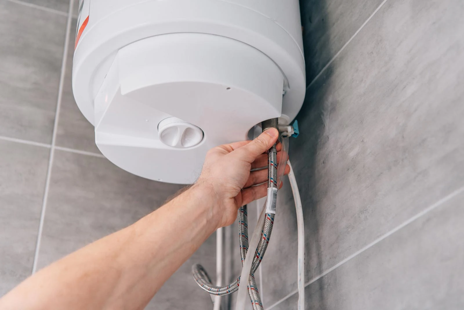plumber repairing electric water heater